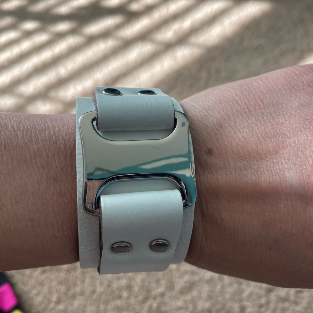White cuff bracelet with silver details.